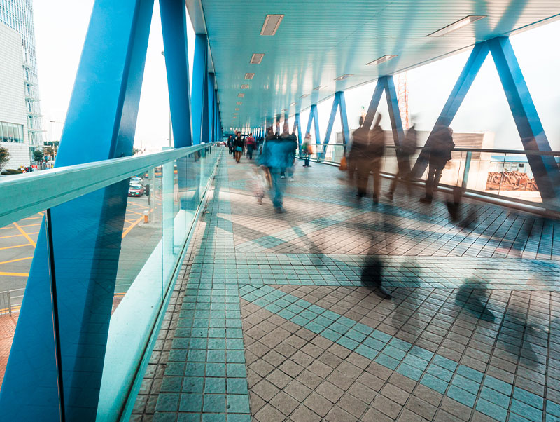 People moving briskly across skyway walk